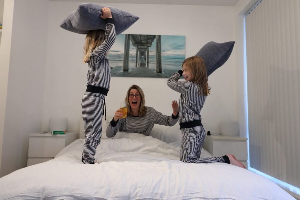 girls jumping on bed as I drink Berocca